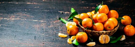 Fresh tangerines with leaves in a basket. photo