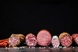 Various slices of salami sausage in a row. photo