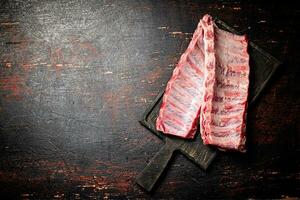 Raw ribs on a cutting board. photo