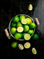 Fragrant lime with leaves in a colander. photo