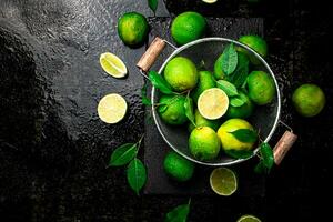 Fragrant lime with leaves in a colander. photo