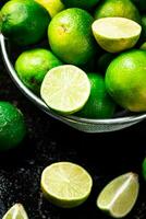 Fragrant lime with leaves in a colander. photo