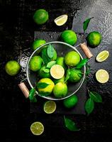 Fragrant lime with leaves in a colander. photo