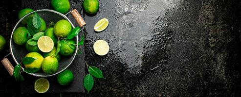 Fragrant lime with leaves in a colander. photo