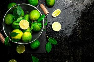 Fragrant lime with leaves in a colander. photo