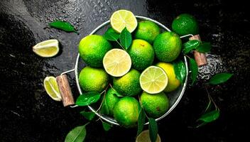 Fragrant lime with leaves in a colander. photo