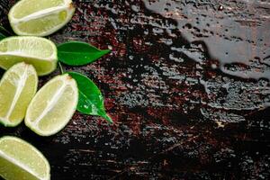 Pieces of fresh lime with foliage. photo