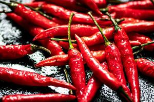 Pods of hot chili peppers on the table. photo