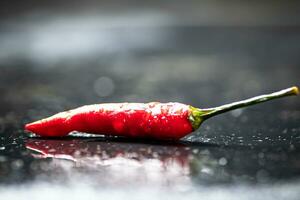 Pods of hot chili peppers on the table. photo