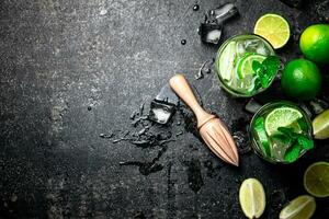 Traditional mojito with pieces of lime and mint. photo