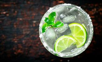 Margarita with mint and ice cubes. photo