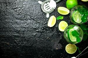 Mojito with pieces of lime and mint leaves. photo