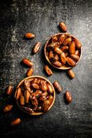 Two plates of dates on the table. photo