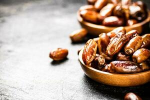 Two plates of dates on the table. photo