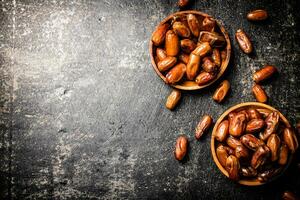 Two plates of dates on the table. photo