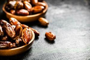 Two plates of dates on the table. photo