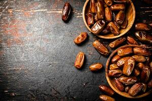 Delicious dates on a wooden plate. photo