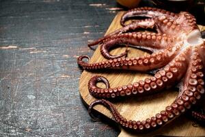 Octopus on a wooden cutting board. photo