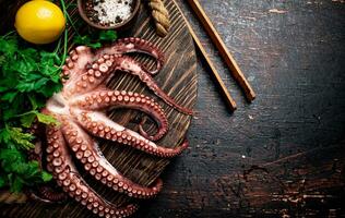 Fresh octopus on a wooden tray. photo