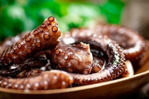 An octopus on a wooden plate. photo