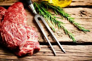 Fresh raw steak with fork. photo