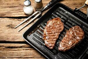 Grilled steak in a frying pan. photo