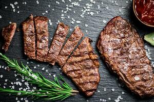 Grilled steak with a sprig of rosemary. photo