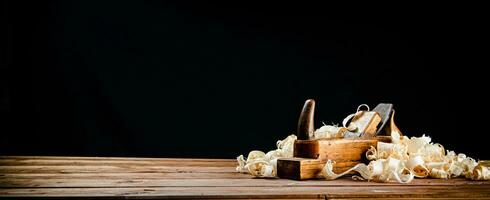 Hand planer on wood. On a black background. photo