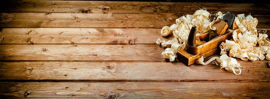 Hand planer with wooden sawdust. photo