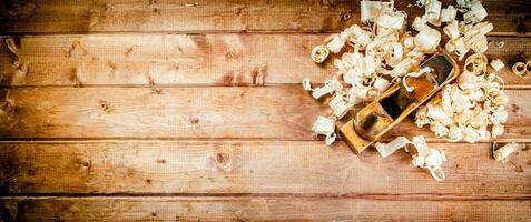 Hand planer with wooden sawdust. photo