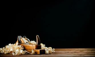 Hand planer on wood. On a black background. photo