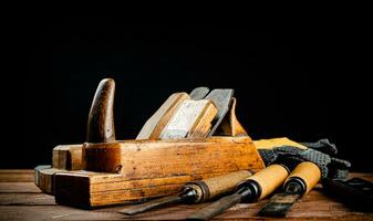 Hand planer on wood. On a black background. photo