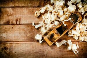 Hand planer with wooden sawdust. photo