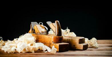 Hand planer on wood. On a black background. photo