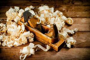 Hand planer with wooden sawdust. photo