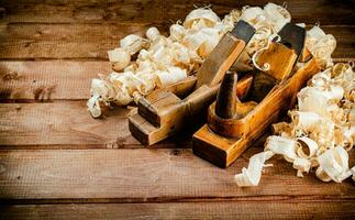 Hand planer with wooden sawdust. photo