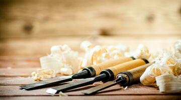 Chisel with a bunch of wood sawdust. photo