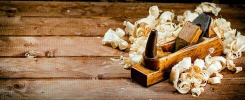 Hand planer with wooden sawdust. photo