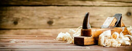 Hand planer with wooden sawdust. photo