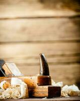 Hand planer with wooden sawdust. photo