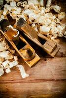 Hand planer with wooden sawdust. photo