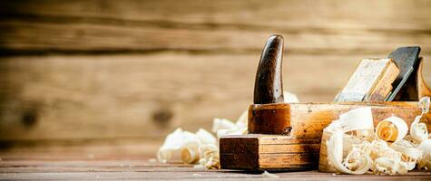 Hand planer with wooden sawdust. photo