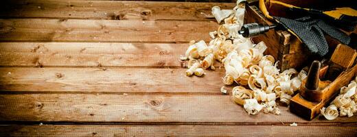 Hand planer with wooden sawdust. photo