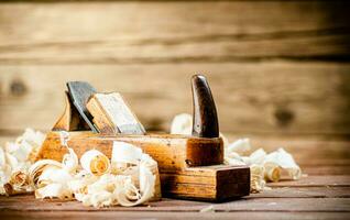 Hand planer with wooden sawdust. photo