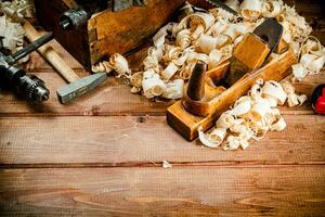 Hand planer with wooden sawdust. photo