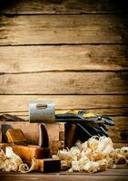 Hand planer with wooden sawdust. photo