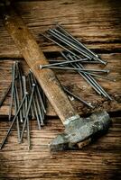 A bunch of nails on the table. photo