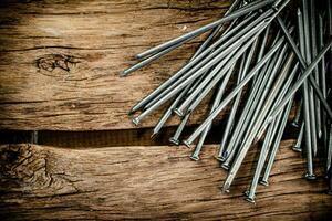 A bunch of nails on the table. photo