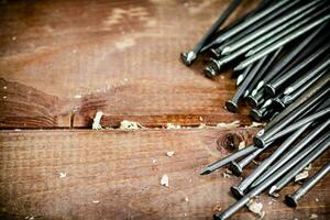 A bunch of nails on the table. photo