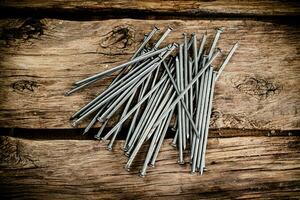 A bunch of nails on the table. photo